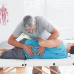 doctor-examining-man-back_13339-123438.jpg